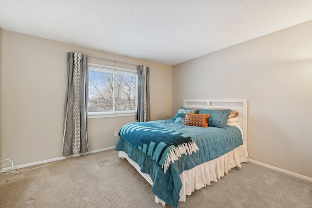 bedroom featuring carpet floors and a textured ceiling