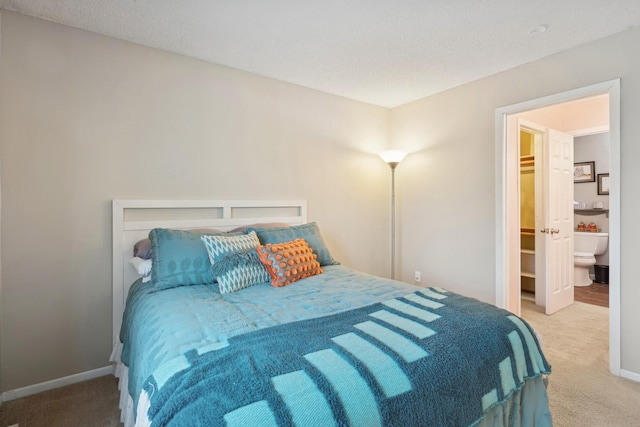 carpeted bedroom with ensuite bath