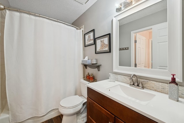 bathroom featuring vanity, a shower with shower curtain, a textured ceiling, and toilet