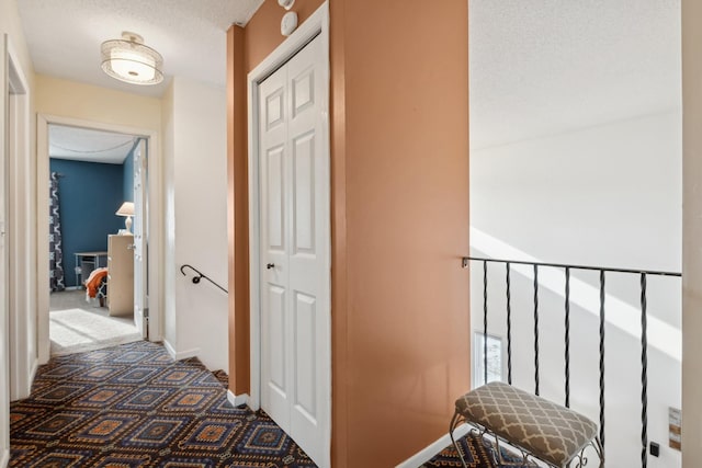 corridor featuring a textured ceiling