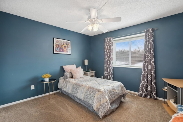 carpeted bedroom with a textured ceiling and ceiling fan