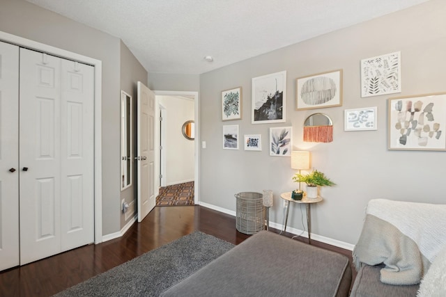 interior space with dark wood-type flooring and a textured ceiling