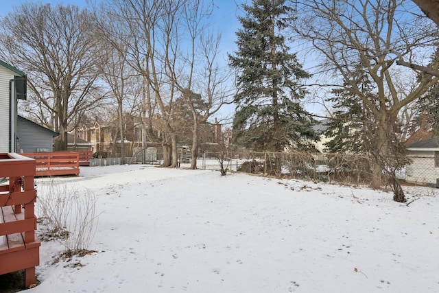 snowy yard with a wooden deck