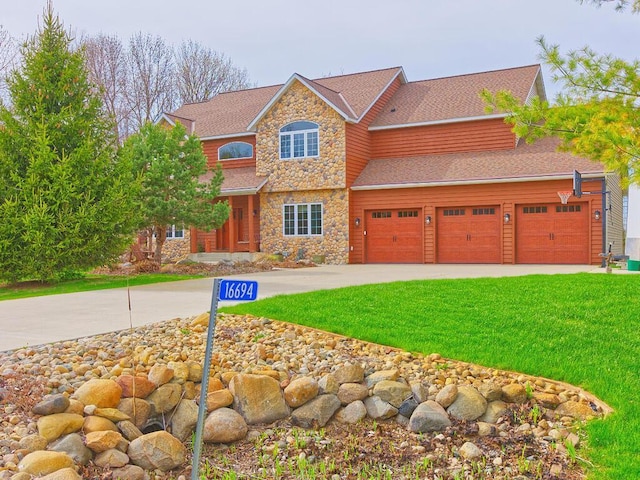 16694 206th Cir, Hutchinson, MN 55350 - view of front of house with stone siding, driveway, a front yard, and roof with shingles