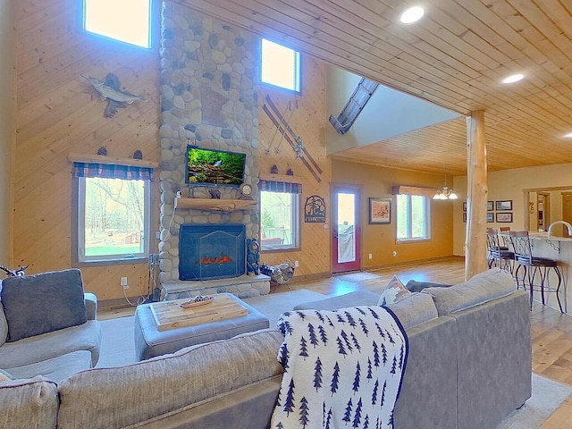 16694 206th Cir, Hutchinson, MN 55350 - living room featuring wood finished floors, a stone fireplace, wooden ceiling, and recessed lighting