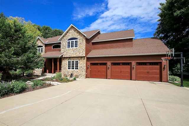 16694 206th Cir, Hutchinson, MN 55350 - view of front of property featuring stone siding, driveway, a garage, and a shingled roof