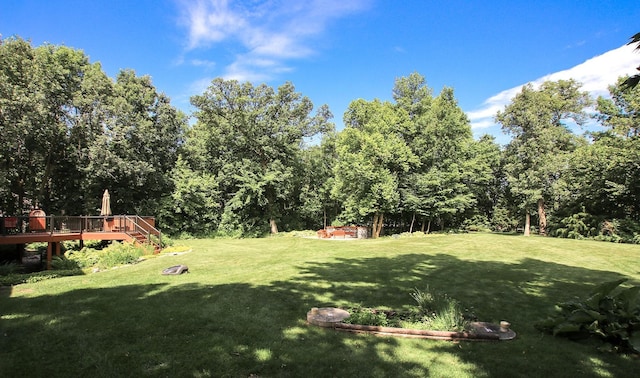 16694 206th Cir, Hutchinson, MN 55350 - view of grassy yard featuring a deck and a wooded view