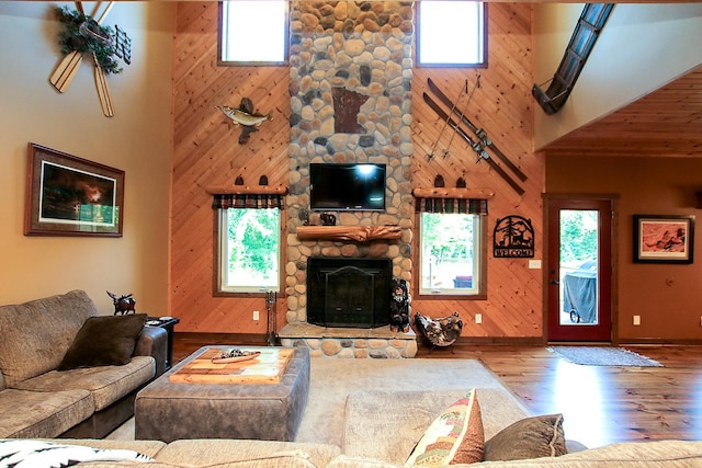 16694 206th Cir, Hutchinson, MN 55350 - living room with a high ceiling, wood finished floors, a stone fireplace, and wood walls