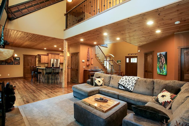 16694 206th Cir, Hutchinson, MN 55350 - living room featuring stairs, recessed lighting, wooden ceiling, light wood finished floors, and a towering ceiling
