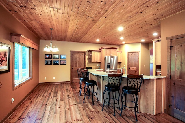 16694 206th Cir, Hutchinson, MN 55350 - kitchen featuring stainless steel fridge, recessed lighting, a peninsula, a kitchen bar, and a chandelier