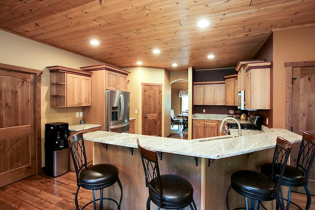 16694 206th Cir, Hutchinson, MN 55350 - kitchen with stainless steel fridge with ice dispenser, a peninsula, open shelves, dark wood-style floors, and light stone countertops