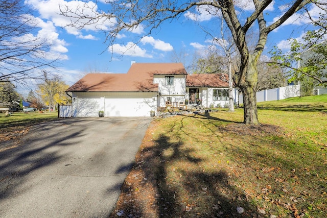 view of front of house with a front lawn and a garage