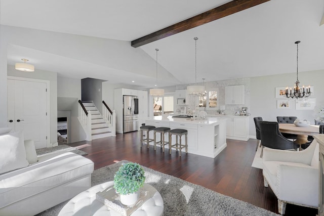 living room featuring a notable chandelier, dark hardwood / wood-style flooring, and vaulted ceiling with beams