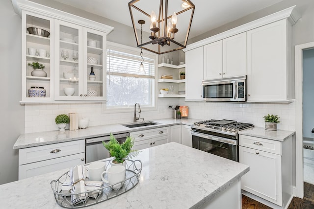 kitchen featuring a sink, stainless steel appliances, open shelves, and white cabinetry