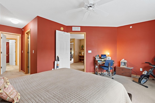 bedroom with visible vents, ceiling fan, a textured ceiling, and carpet flooring