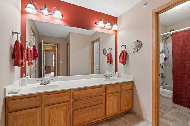 full bath with double vanity, shower / bath combo, and a sink