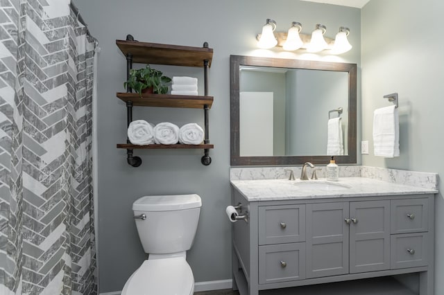 full bathroom with toilet and vanity