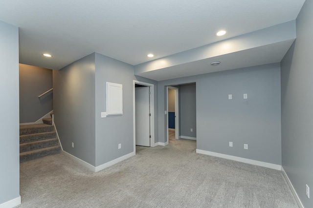 below grade area featuring carpet, stairway, recessed lighting, and baseboards