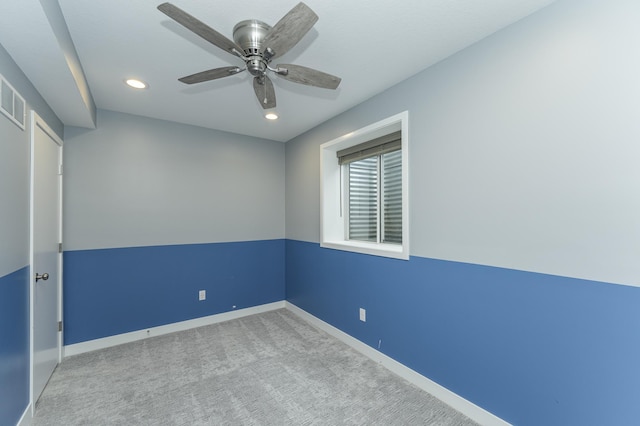 spare room featuring carpet floors, recessed lighting, ceiling fan, and baseboards