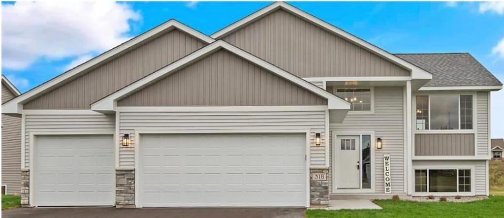 craftsman-style house with a garage and a front lawn