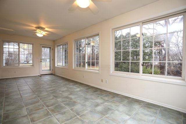 unfurnished sunroom with ceiling fan and a healthy amount of sunlight