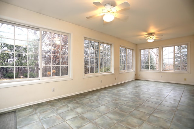 unfurnished sunroom with ceiling fan