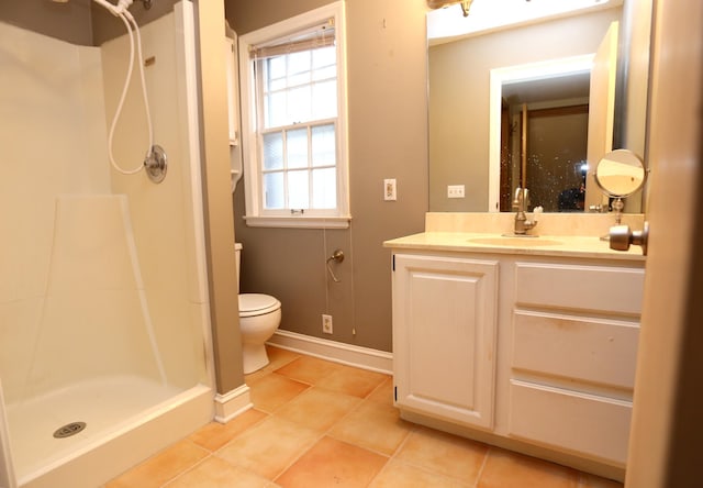 bathroom with toilet, vanity, tile patterned floors, and walk in shower