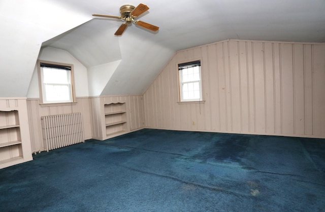 additional living space featuring plenty of natural light, built in features, and ceiling fan