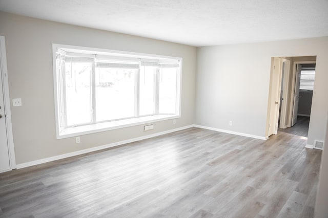 unfurnished room with light hardwood / wood-style floors