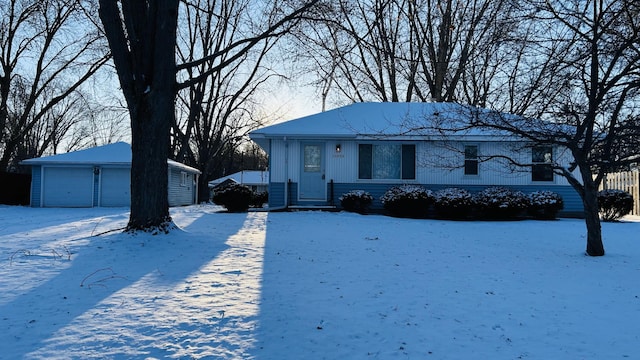 view of front of home with a garage and an outdoor structure