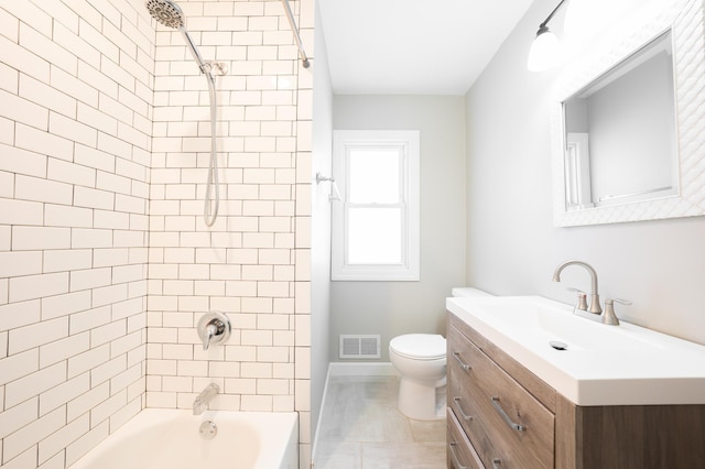 full bathroom with tiled shower / bath, vanity, toilet, and tile patterned flooring