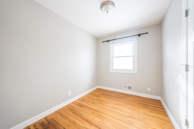 spare room with wood-type flooring