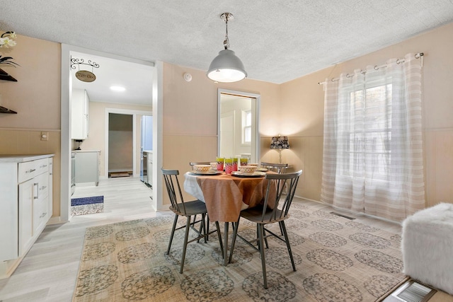 dining area with light wood-type flooring