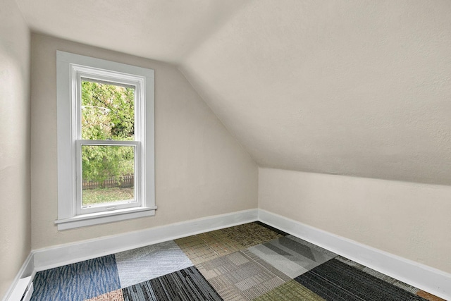 bonus room featuring vaulted ceiling