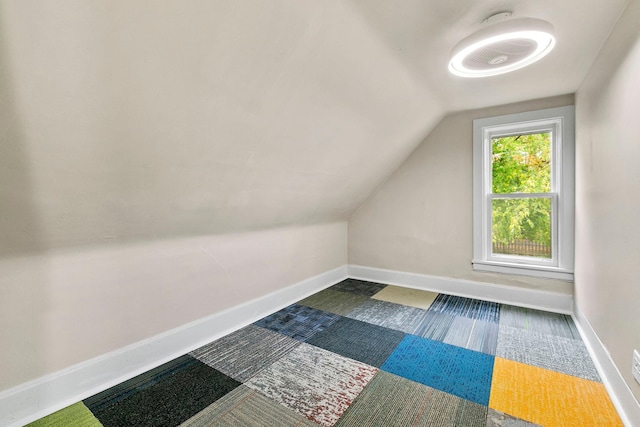 additional living space featuring vaulted ceiling