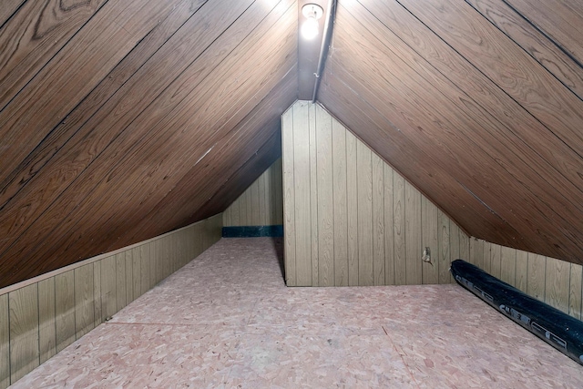 additional living space with wooden ceiling, wood walls, and vaulted ceiling