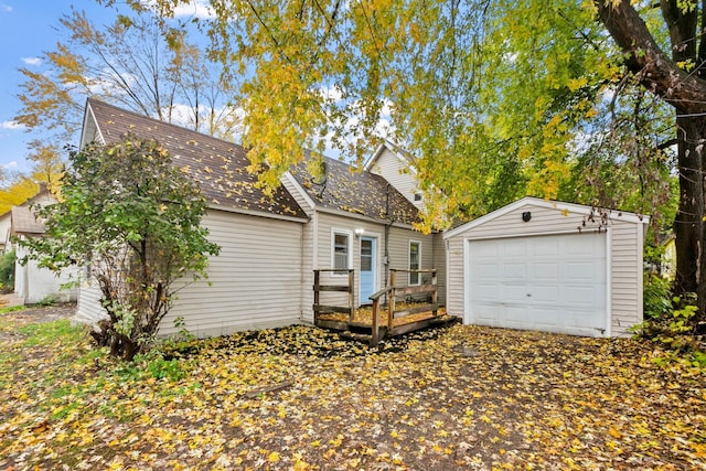 back of property with a garage and an outdoor structure