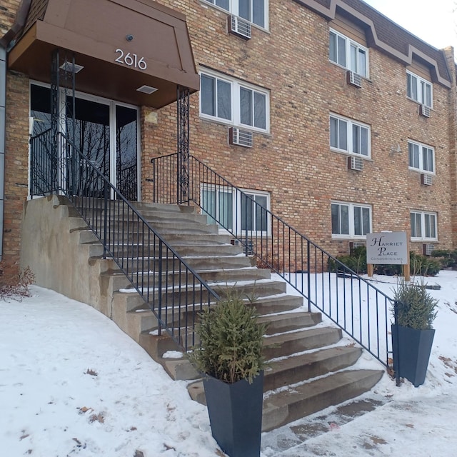 view of snow covered property entrance