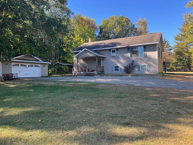 view of front of property featuring a garage and a front lawn