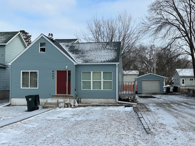 bungalow-style house with a garage and an outdoor structure