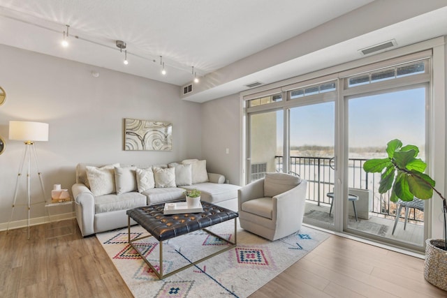 living room featuring hardwood / wood-style floors and track lighting