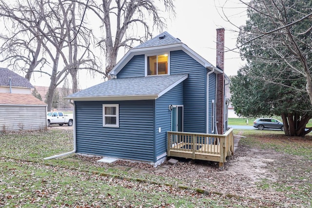 rear view of property featuring a wooden deck