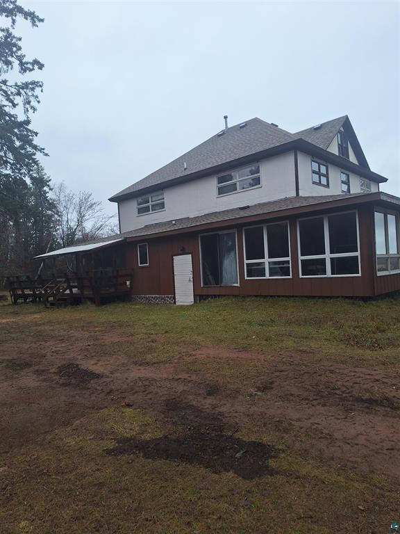 back of property with a sunroom