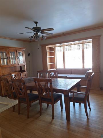 6330 Mitchell Rd, Hughes Twp, WI 54847 - dining room with hardwood / wood-style flooring, ceiling fan, and crown molding