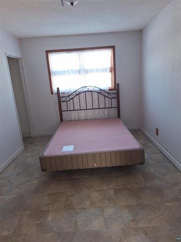 6330 Mitchell Rd, Hughes Twp, WI 54847 - bedroom with a textured ceiling