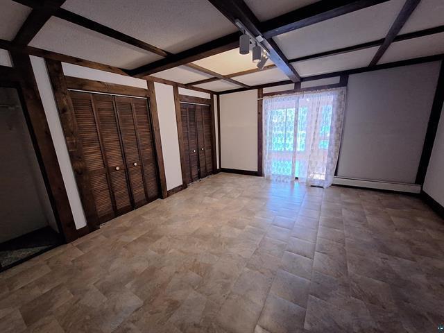 6330 Mitchell Rd, Hughes Twp, WI 54847 - interior space with beam ceiling, coffered ceiling, and multiple closets