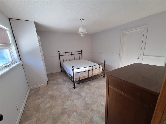 6330 Mitchell Rd, Hughes Twp, WI 54847 - bedroom with a textured ceiling