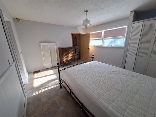 6330 Mitchell Rd, Hughes Twp, WI 54847 - bedroom featuring a textured ceiling