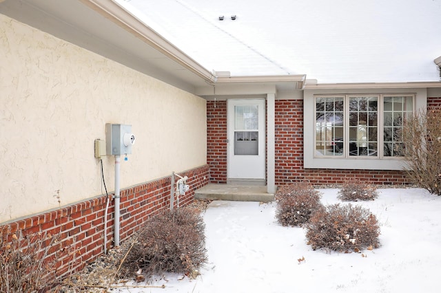 view of snow covered property entrance