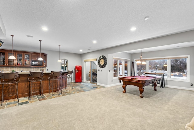 playroom with pool table, bar, a textured ceiling, and light carpet